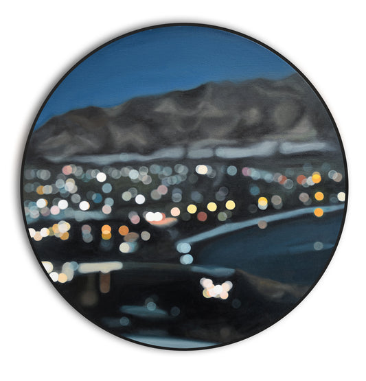 Wanaka, New Zealand oil painting in a bokeh style on a round canvas in a black frame. Lakefront lights