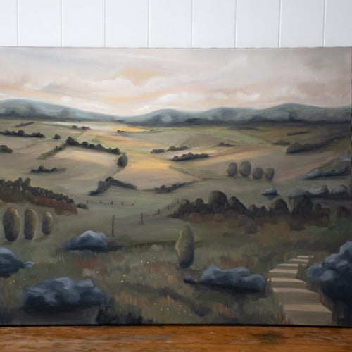 Large oil painting of sunset over rural landscape